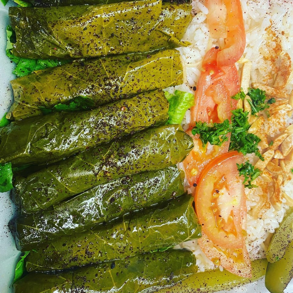 Shish Kabob Xpress's stuffed grape leaves with rice, tomatoes, and pickled cucumbers.