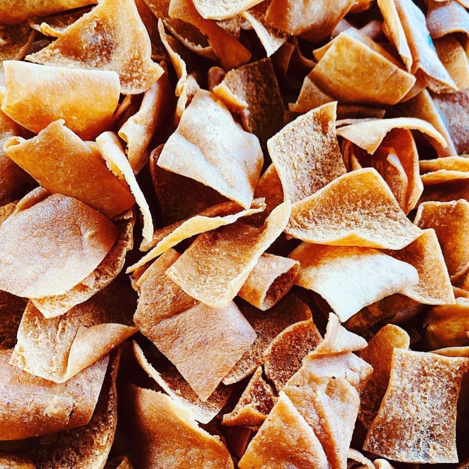 Close-up of golden-brown, crispy Middle Eastern pita chips or crackers.