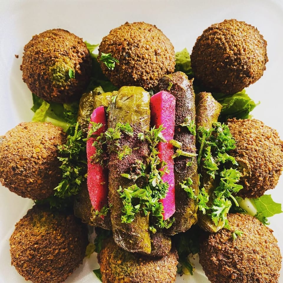 Shish Kabob Xpress falafel and stuffed grape leaves with pickled turnips and parsley.